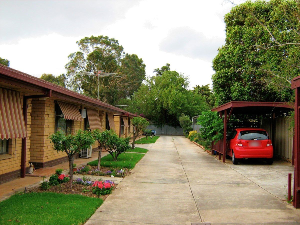 Long concrete driveway and carport after cleaning